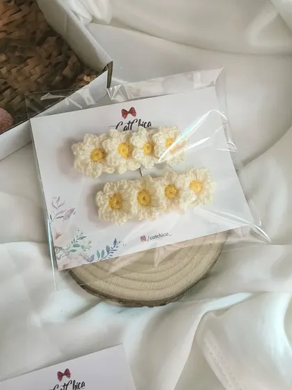 A pair of our adorable daisy hair clips, packaged and ready to gift.