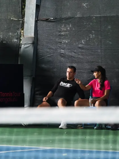 A quiet moment of coaching on the sidelines of the World Tennis Tour W25 event in Bengaluru. Our coach provides tactical advice and encouragement during a match.
