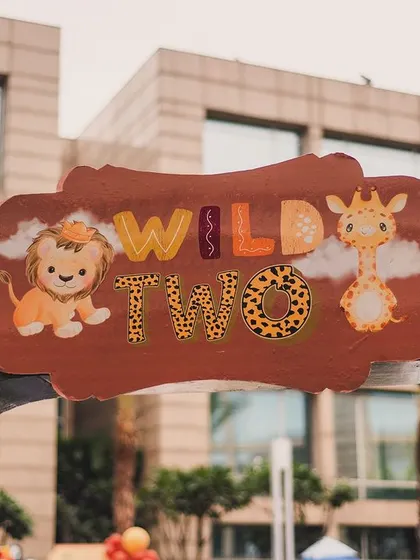 The custom 'Wild Two' entrance sign, featuring cute cartoon animals. This sign immediately sets a fun and adventurous tone for the party.