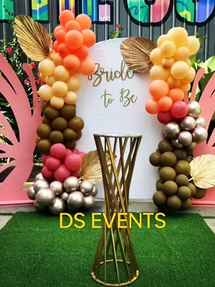 A chic and modern "Bride to Be" backdrop. The design features large butterfly wings, stylish balloon clusters, and a simple pedestal, creating a trendy photo booth for a bridal shower.