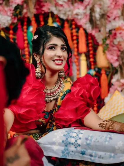 The intricate details of the bride's henna stand out against the colourful decor. I always aim to create a backdrop that complements the bride's attire and the ceremony's traditions.