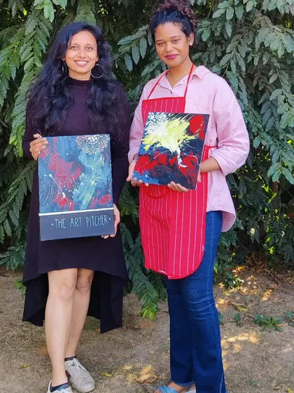 Posing with one of the participants and her vibrant finished artwork. It's always rewarding to see the unique pieces that emerge from these team building sessions.
