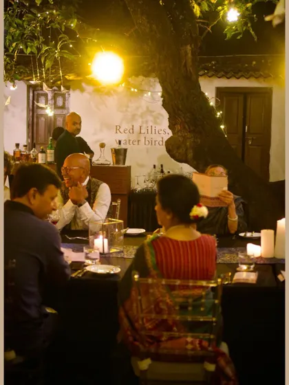 Another shot of guests dining at the saree exhibition, with the event's name visible in the background.