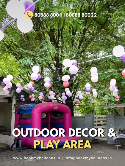 This image of an outdoor play area with a bouncy castle and balloon decorations shows that our services go beyond just backdrops. We can help plan fun activities to make your child's party unforgettable.
