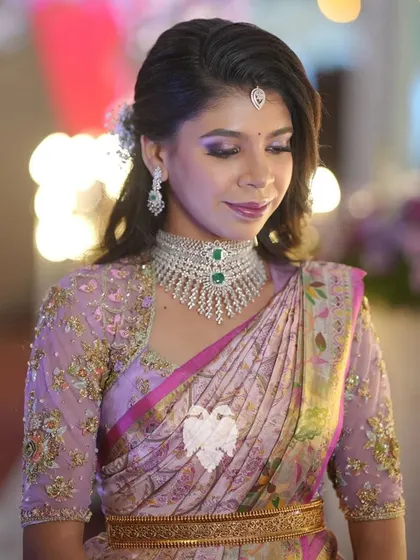 Priyanka, a blushing bride in her lilac blush blouse with sheer sleeves and back boasting gorgeous floral details.