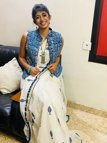 My daughter wearing our white cotton saree with a modern twist, styled with an indigo jacket for Day 1 of Navratri.