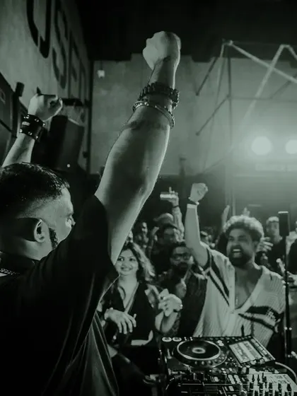 A black and white shot of me with my hands raised in triumph, connecting with the crowd. This is a moment of pure, shared energy.