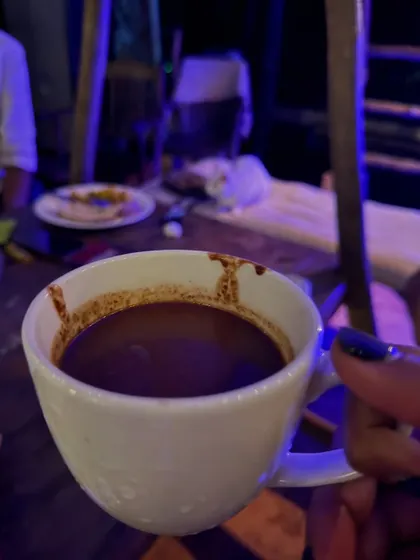 A close-up of a cup of ceremonial cacao. This rich, heart-opening drink is a central part of our restorative group ceremonies.