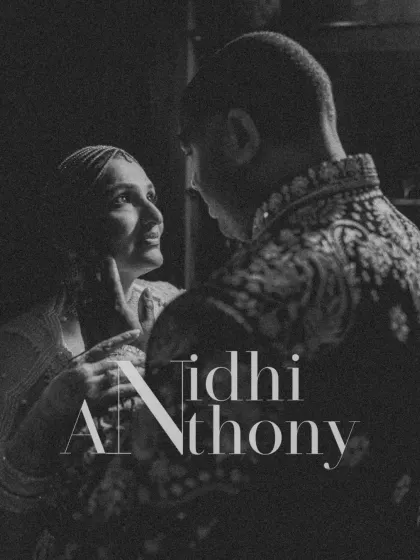 A moody and intimate black and white portrait from a Sangeet in Udaipur. The dramatic lighting highlights their close bond and the romance of the night.