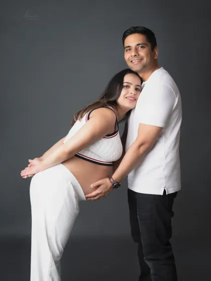 A sweet and supportive pose. The mom-to-be leans against her partner, a beautiful picture of trust and togetherness.
