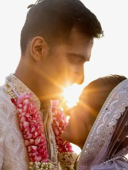 A creative sun-flare portrait. I positioned the couple so the setting sun bursts between them, creating a star-like effect that symbolizes their radiant love.