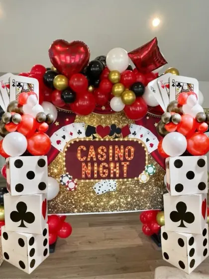 Here's another amazing casino night setup using our DIY dice panels. Combined with a glittering backdrop and a massive balloon arch, it creates a high-energy, exciting atmosphere for any card party.