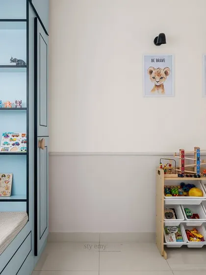 A detail of the kids' room showing the organized toy storage and personalized wall art. We kept the center of the room free so he has plenty of space to run and play.