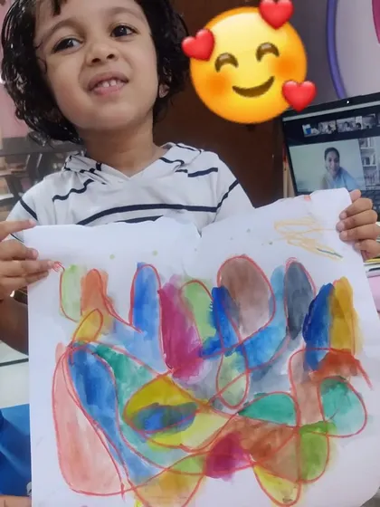 Another happy artist from our online "dot for a walk" session. We love seeing the pride children feel in their work, and we make sure to celebrate every unique creation in our virtual classroom.
