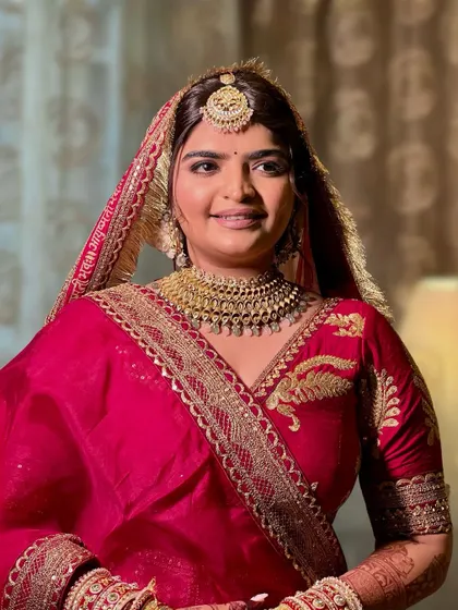 A portrait of the bride, her makeup perfectly complementing her traditional attire and jewelry.