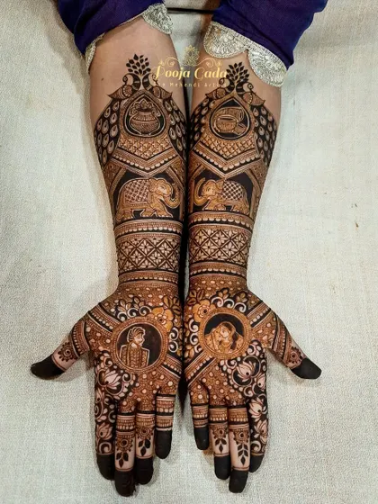 A classic bridal design with portraits of the bride and groom in circular frames, surrounded by royal elephants and intricate patterns.