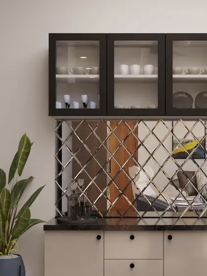 This sleek, modular crockery unit features a stunning diamond-patterned mirror backsplash that creates the illusion of a larger space. The black-framed glass cabinets and granite countertop add a touch of modern luxury.