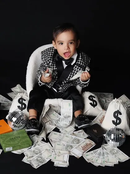 This 'Little Boss' theme is all about fun and attitude. Dressed in a sharp suit, this toddler is surrounded by playful money props, creating a hilarious and memorable kids portrait.