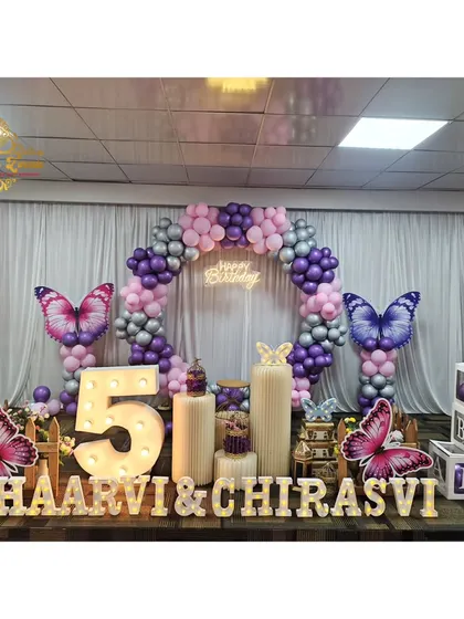 A duplicate image of the stunning butterfly-themed stage decoration for the twins' birthday.