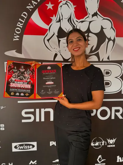 My client Preeti with her certificate at the WNBF Singapore event. Her hard work and dedication to her posing practice paid off on an international stage.