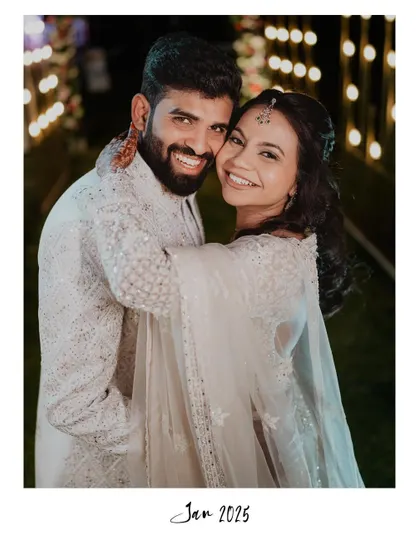 A joyful and candid portrait of Adarsh and Premika, their smiles lighting up the night.