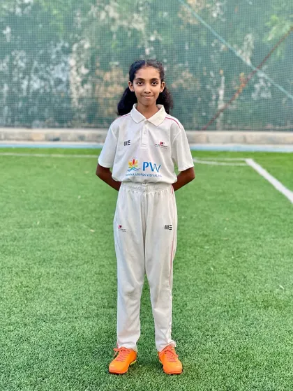 A portrait of one of our young female players in her full cricket kit, ready to take on any challenge on the field.