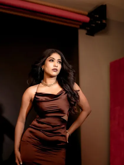 A three-quarter portrait where the model is looking away from the camera, lit by a soft studio light. This creates a thoughtful and slightly distant mood, adding a layer of narrative to the image.