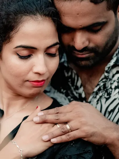 A close-up shot focusing on the gentle touch and connection between the couple, highlighting their wedding rings.