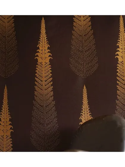 This resplendent 'Sacred Tree' fabric showcases a beautiful contrast of gold motifs against a dark, plain background. It's a perfect example of a fabric that adds a touch of regal elegance.