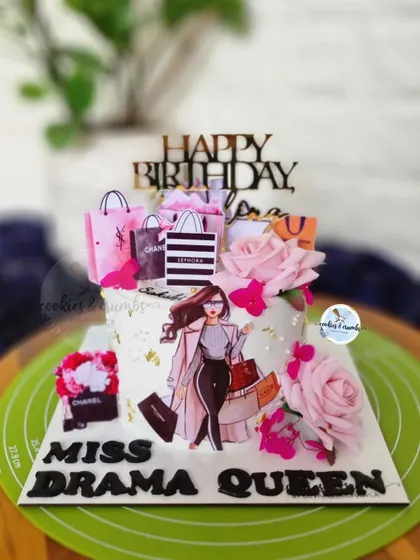 The perfect cake for a shopaholic. This design is decorated with edible toppers of designer shopping bags like Chanel and Sephora, along with fresh pink roses.