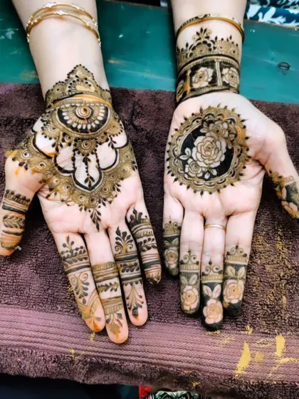 A stunning design with a central rose mandala on one hand and a traditional pattern on the other.