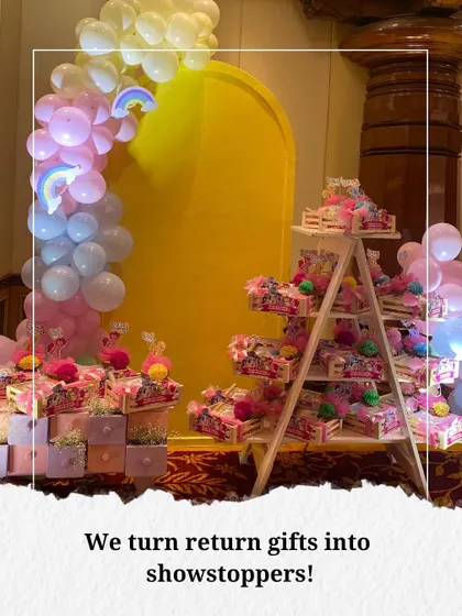 We believe in turning party favors into a stunning display. For this "My Little Pony" theme, we arranged the return gifts on a ladder shelf and in a custom drawer unit, making them part of the magical decor.