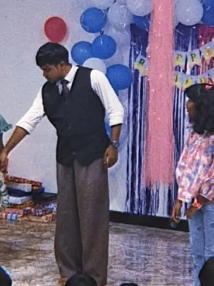 Two young assistants help me on stage during a birthday party performance. Having friends participate together adds an extra layer of fun to the magic show.