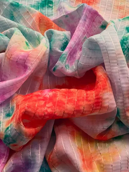 This Tabby Silk Tie-Dye fabric features a beautiful blend of colors, creating a unique and artistic look for any outfit.