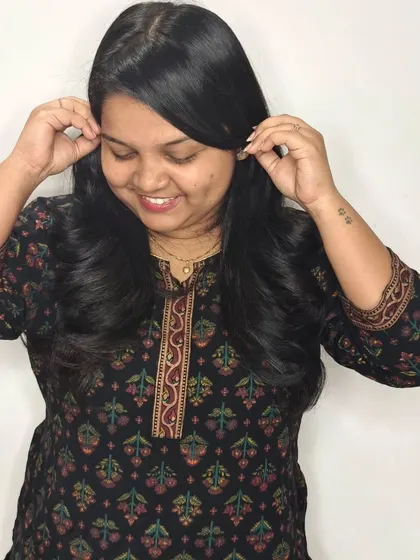 This client is loving her cute new look for Diwali, featuring soft layers and a happy smile.