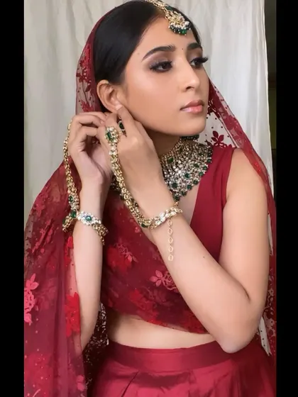 A still from the video, capturing the model adjusting her jewelry.