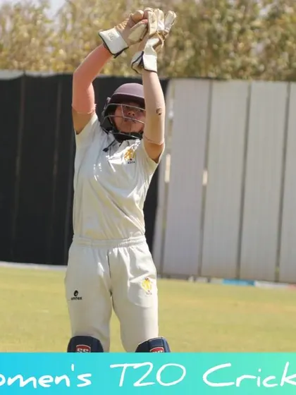 A wicketkeeper appeals for a catch during a competitive match.