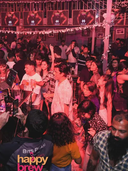 A wide shot of the crowd at Happy Brew, completely engaged in the karaoke night. The energy was fantastic.