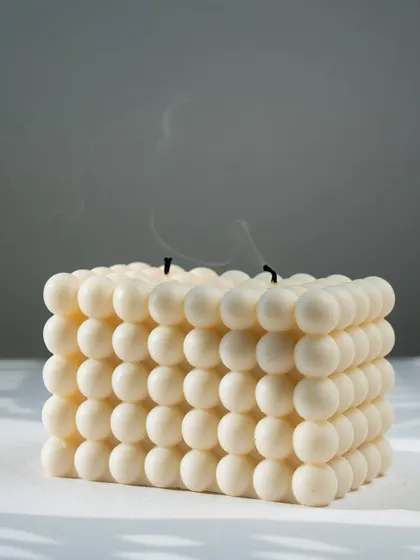 Our large bubble candle, just extinguished. The clean, white soy wax and modern shape make it a stylish decor piece.