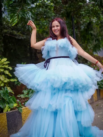 A playful twirl in the blue ruffle gown. The layers of tulle create beautiful movement and volume.