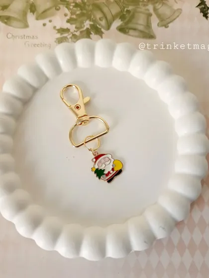 Simple and festive. This single Santa charm on a gold clasp is a minimalist way to add some Christmas cheer to your bag or keys.
