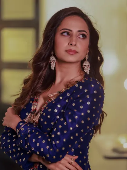 Sargun Mehta strikes a pose in a beautiful blue outfit, her look completed by the timeless elegance of my jhumka earrings.