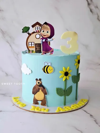 A Masha and the Bear cake for a 3rd birthday. This lemon blueberry cake features the beloved characters in a sweet scene with sunflowers and a friendly bee.