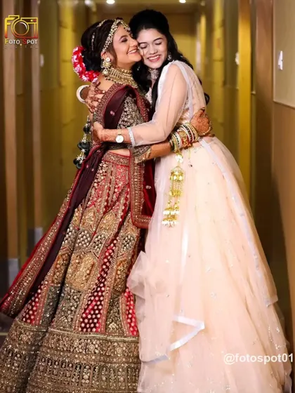 A warm, heartfelt hug between the bride and her sister. This image is filled with emotion and love, a perfect capture of the relationships that are central to a wedding.