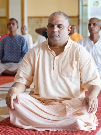Devotees and yoga enthusiasts participating in a meditation session at the ISKCON Temple, finding inner peace and unity.