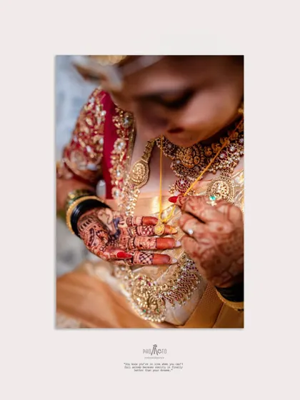 An artistic close-up of the bride looking at her thali or mangalsutra, a photo that tells a story of commitment.