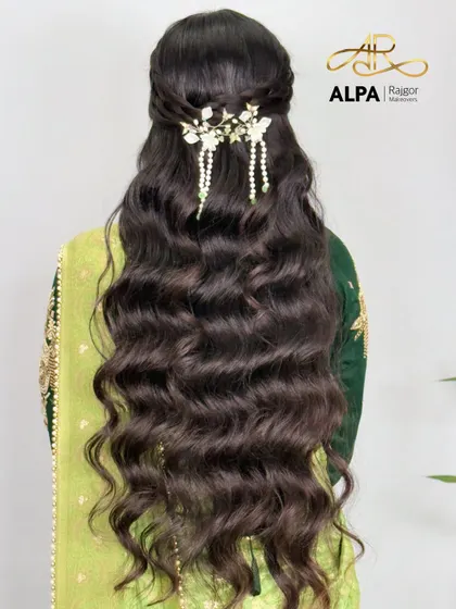 A beautiful half-up hairstyle for long hair, adorned with a delicate handmade white floral and pearl hair clip.