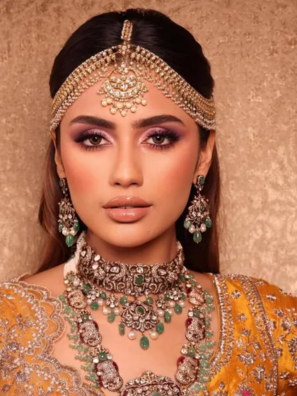 A vibrant and colorful look perfect for a mehendi or sangeet. The purple smokey eye and yellow outfit create a beautiful contrast, a concept we explore in our color theory lessons.