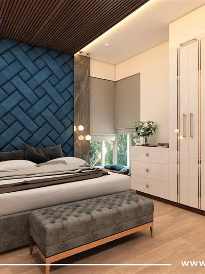 A luxurious master bedroom with a deep blue, herringbone-patterned upholstered accent wall. The wooden ceiling panels and pendant lights add layers of texture and warmth.