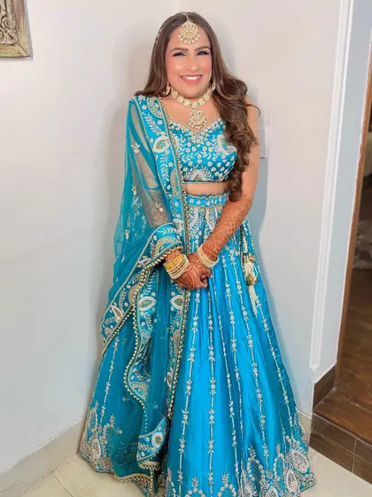 The cute bride-to-be Prakshi ready for her Sangeet ceremony in a vibrant blue lehenga. We gave her a fresh, glowing look to match.